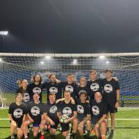 Students wearing championship shirts from a coed soccer tournament